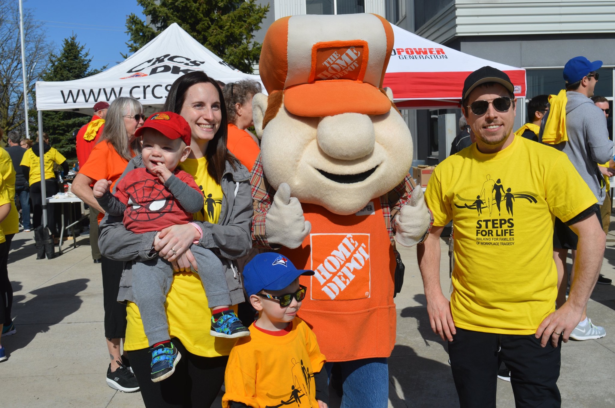 A family and the home depot mascot at a steps for life event.